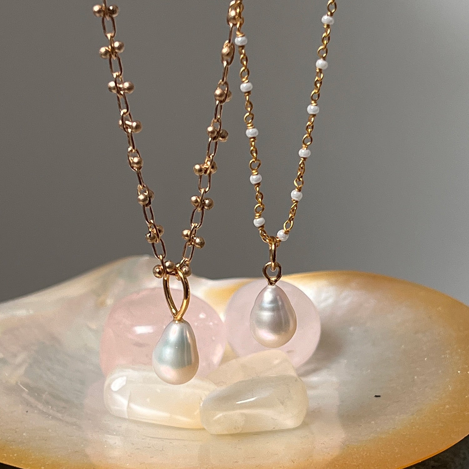 Freshwater pearl pendant necklace on a gold-plated bula chain with crystals in the background