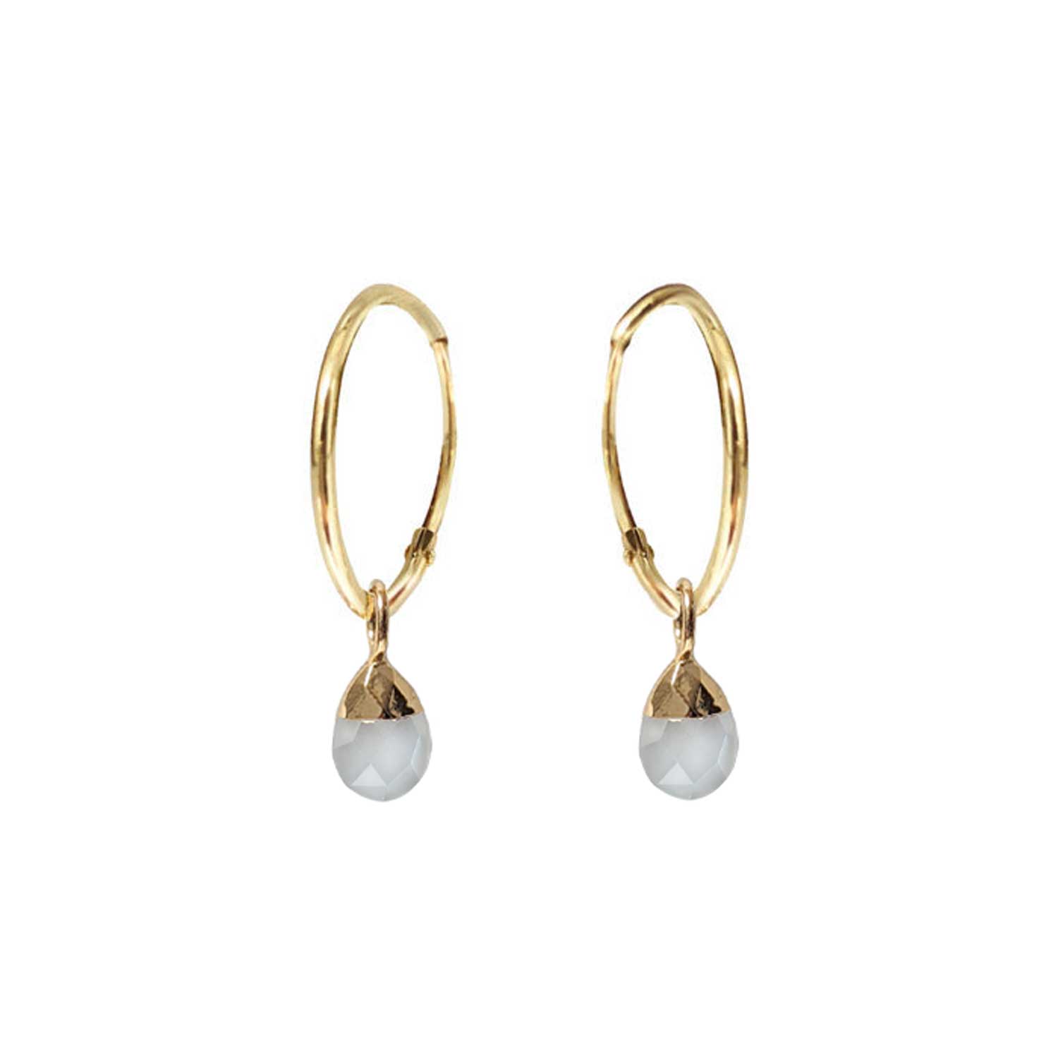 A pair of gold-filled creole earrings with white moonstone briolettes dangles, on a white background.