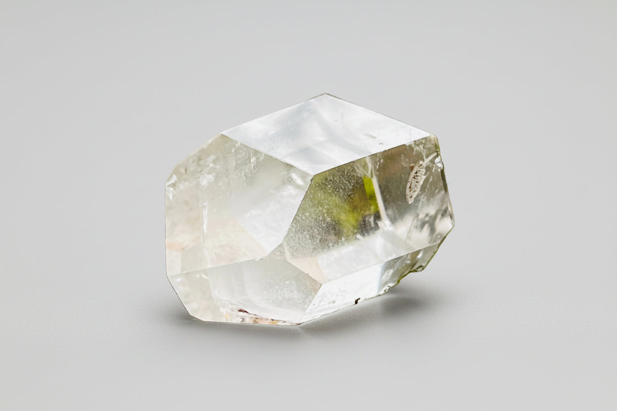 Phantom quartz clear crystal on a grey background