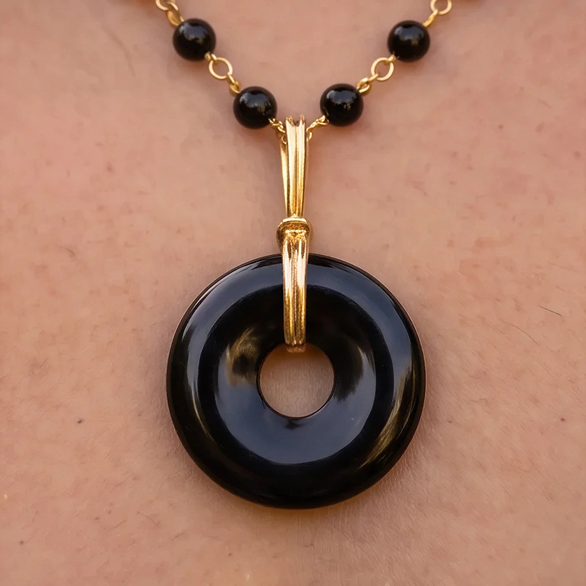 Grounding black onyx disc on short black onyx rosary or Belcher chain
