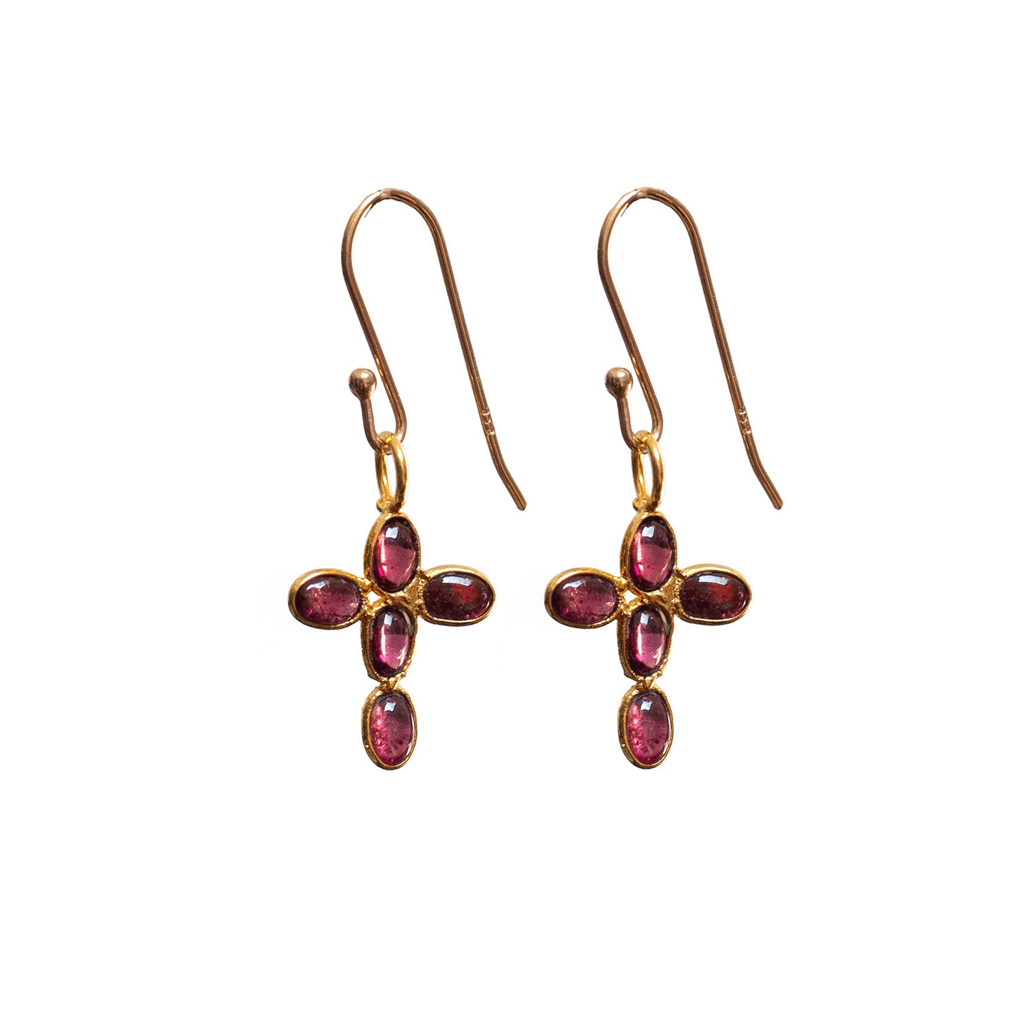 Gold cross earrings with garnet gemstones on a white background