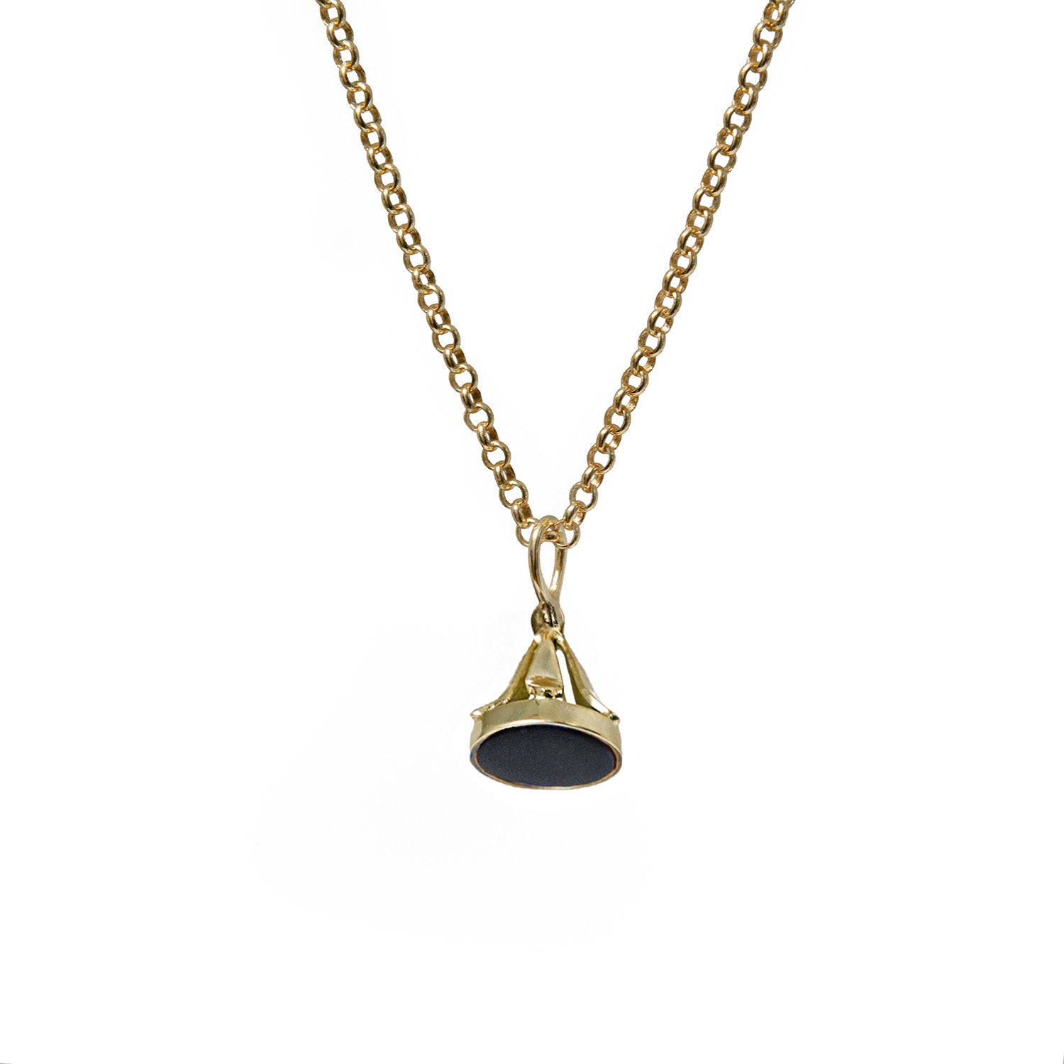 Gold necklace with a black onyx stamp pendant on a white background