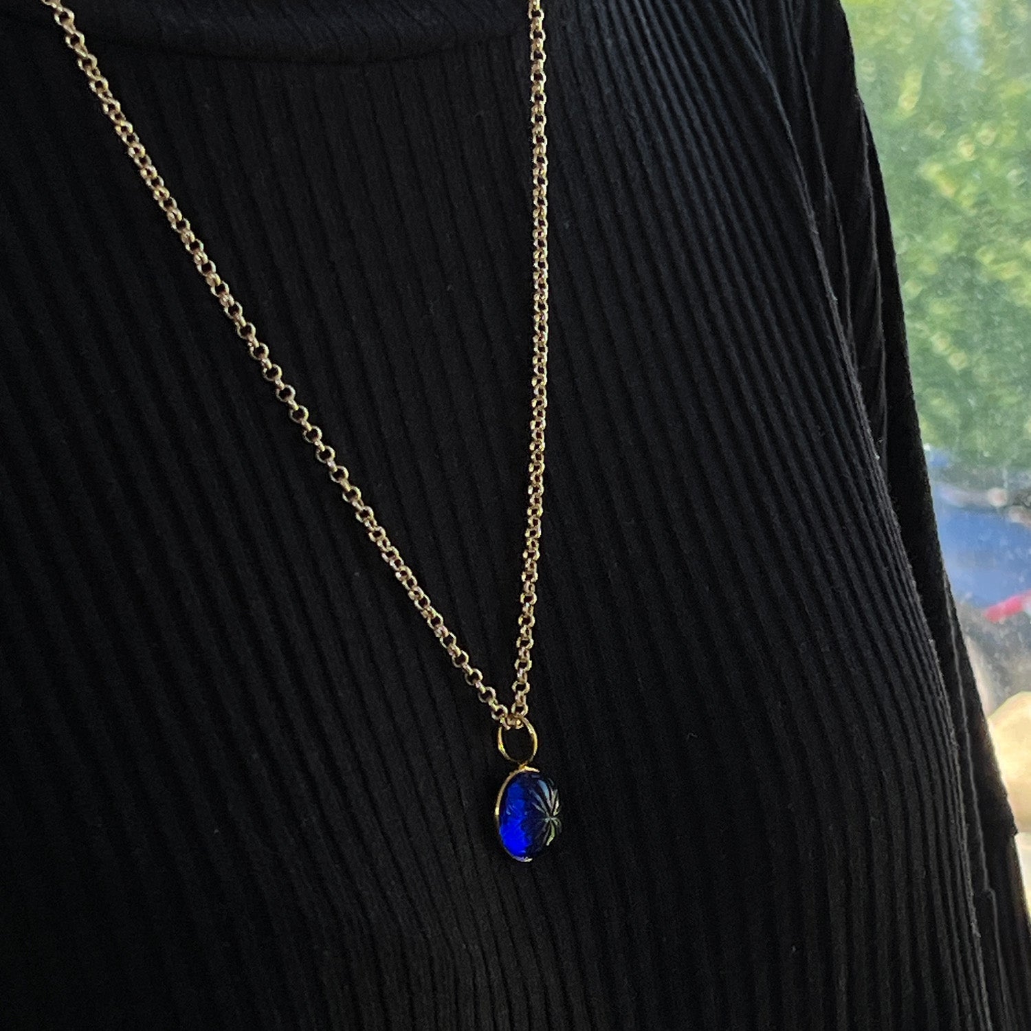 Carved Blue Glass Flower Pendant On Long Baby Belcher