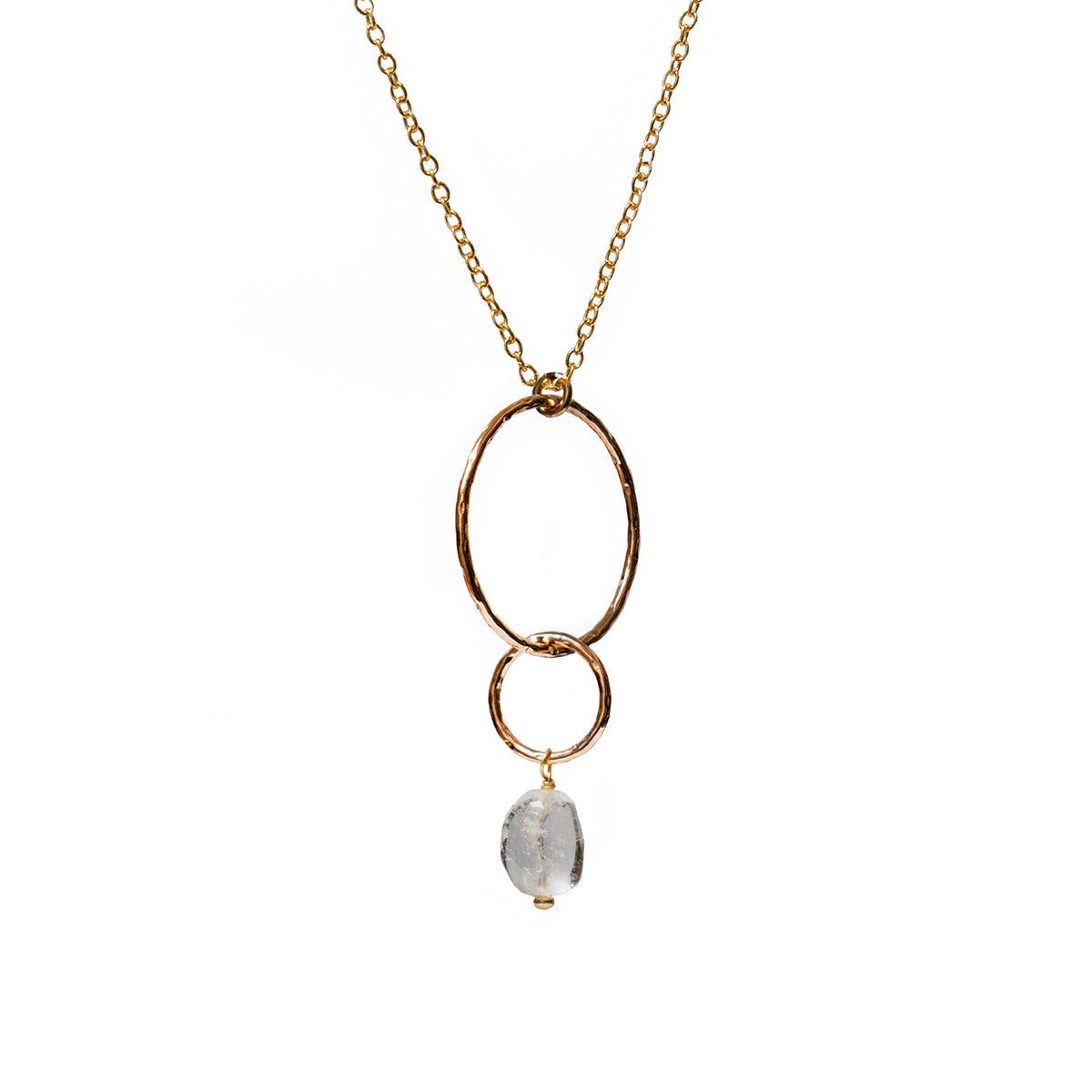 Gold necklace with a freeform rock crystal pendant on a white background