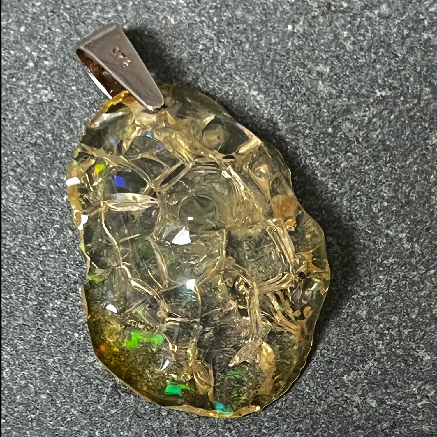 Necklace with a textured unique Ethiopian fire opal pendant on a dark background
