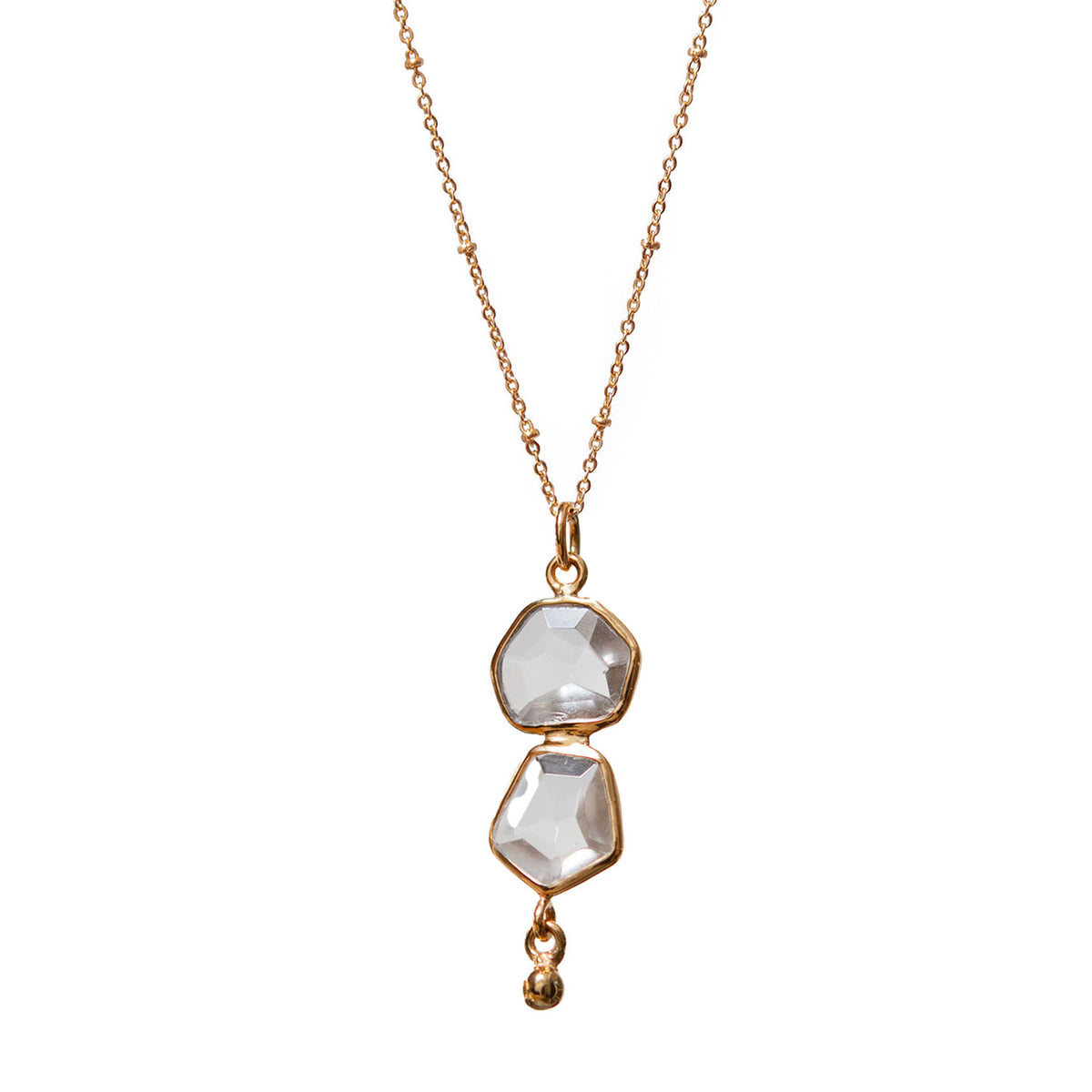 Gold necklace with two clear gemstones on a white background