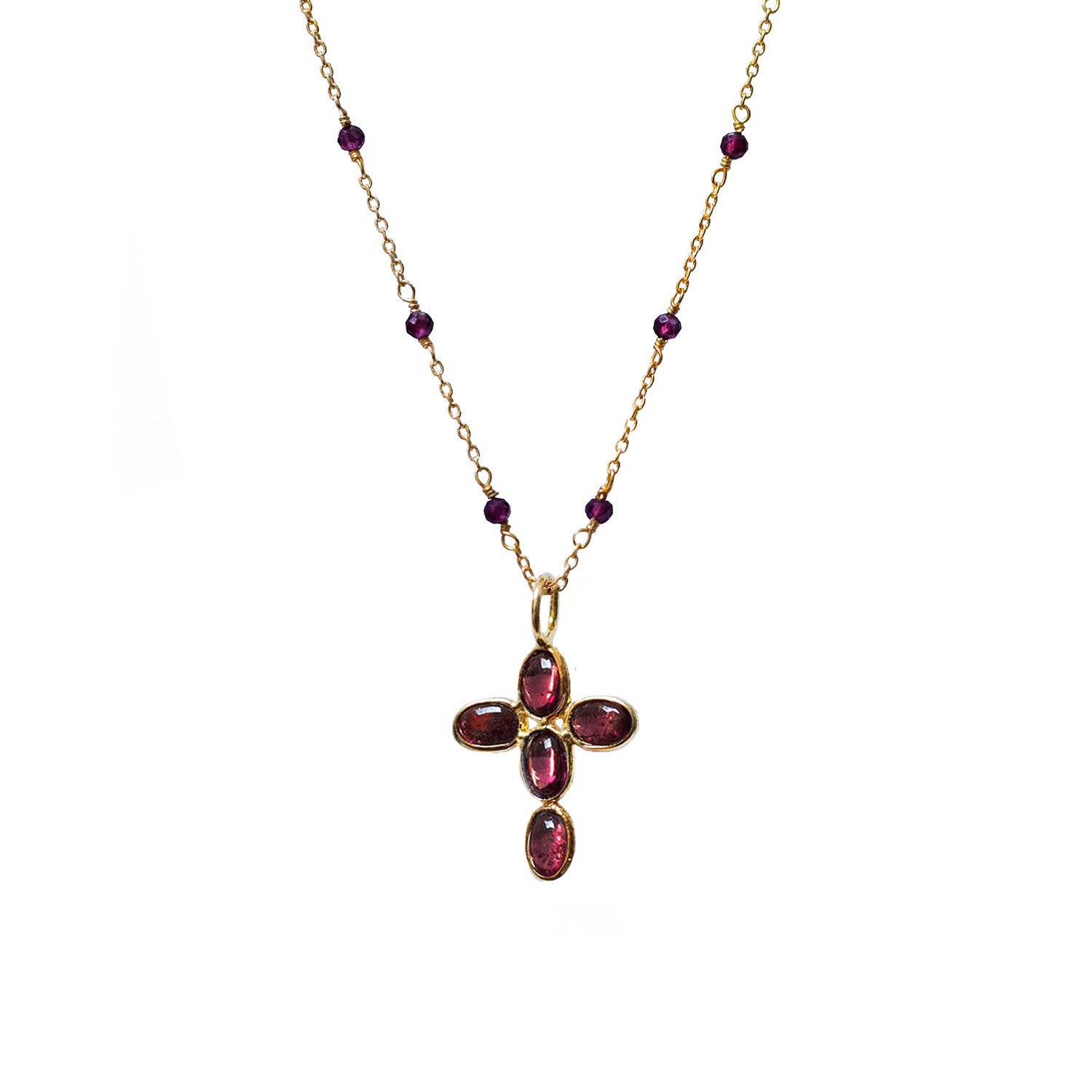 Gold necklace with a cross pendant featuring red garnet gemstones on a white background