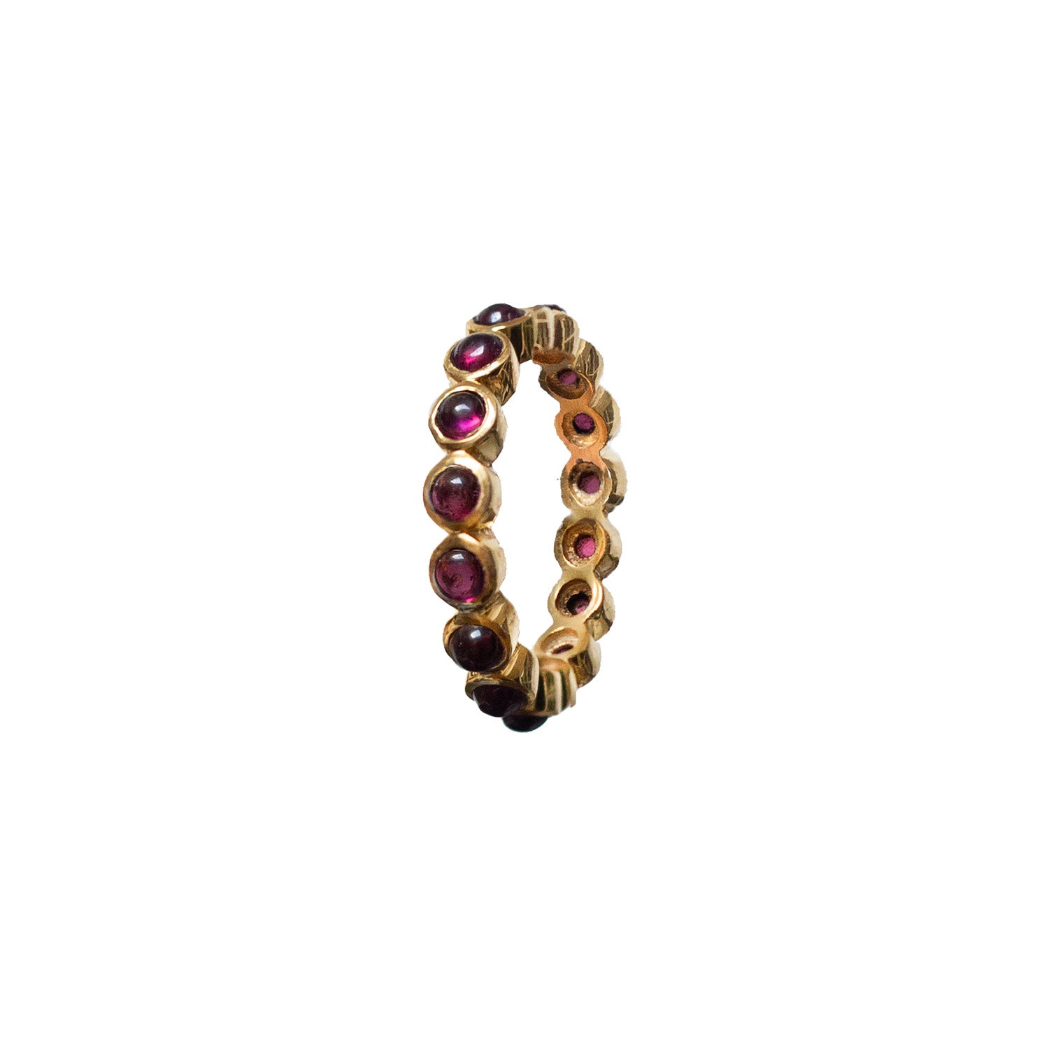 An eternity garnet cabochon ring with gold plating on sterling silver, featuring multiple red gemstones around the band.