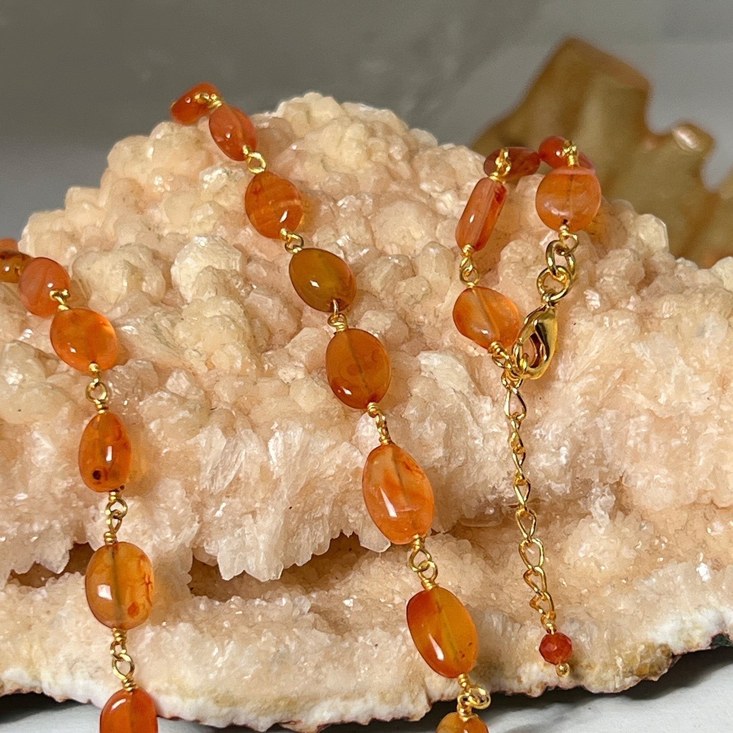 Mirabelle Jewellery Rosary Pebble necklace featuring orange carnelian stones on a 22ct gold plated brass chain.