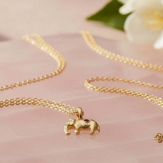 Mirabelle Jewellery tiny 3D elephant pendant in 22ct gold plated brass with a small ruby accent on a long chain