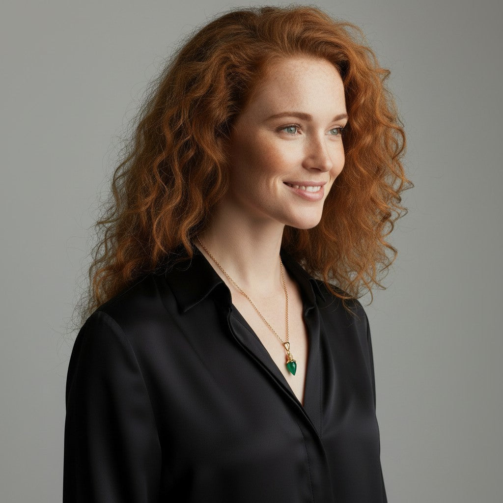 Mirabelle Jewellery green onyx pendulum pendant on a short gold-plated brass belcher chain worn by a woman with red curly hair.