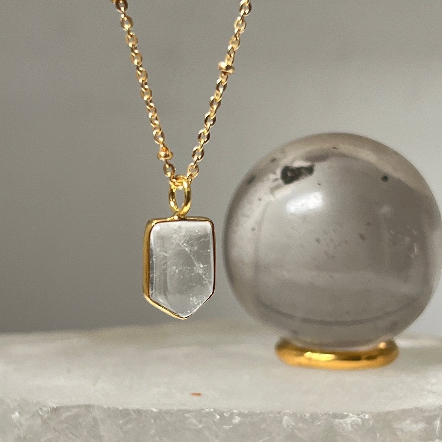 Mirabelle Jewellery gold-plated brass necklace featuring a mini temple rock crystal pendant on a satellite chain.