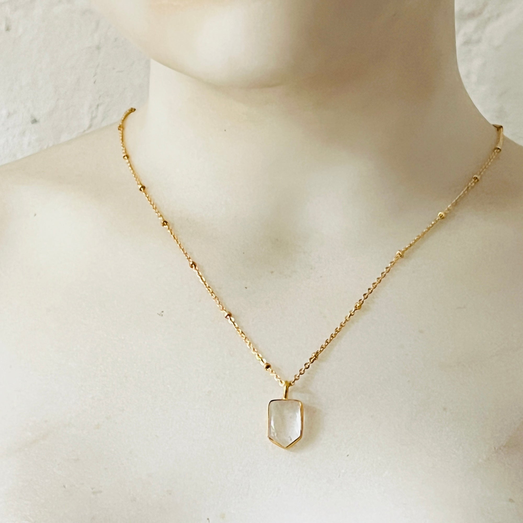 Mirabelle Jewellery Mini Temple necklace featuring a clear rock crystal pendant on a gold-plated satellite chain.