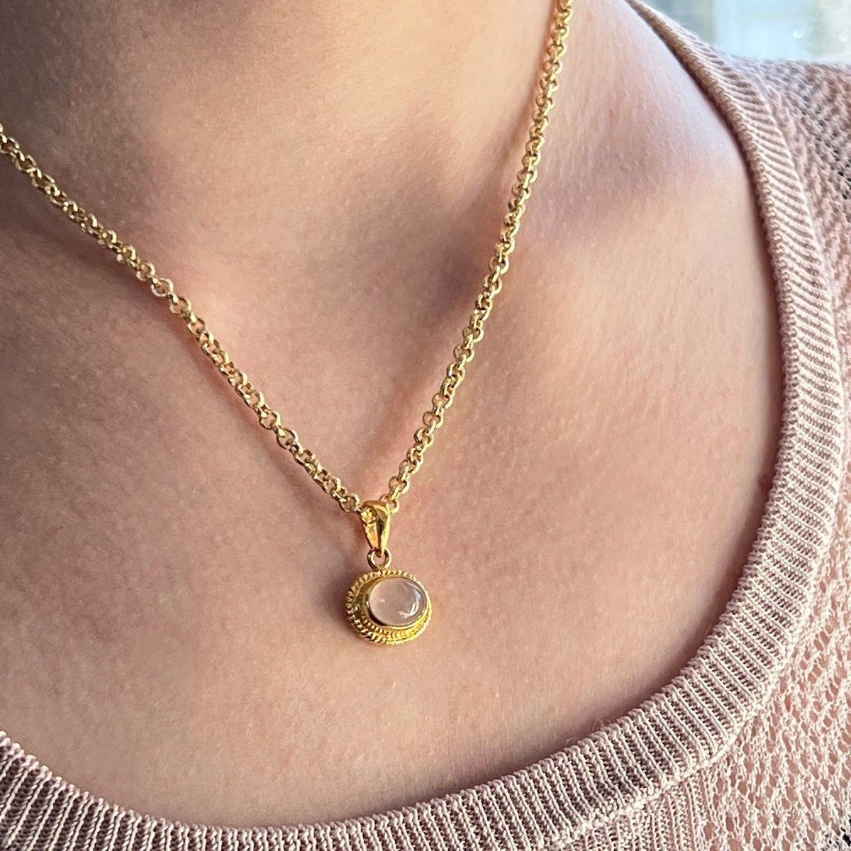 Mirabelle Jewellery Athena rose quartz pendant on a 22ct gold plated brass baby belcher chain worn on a model.