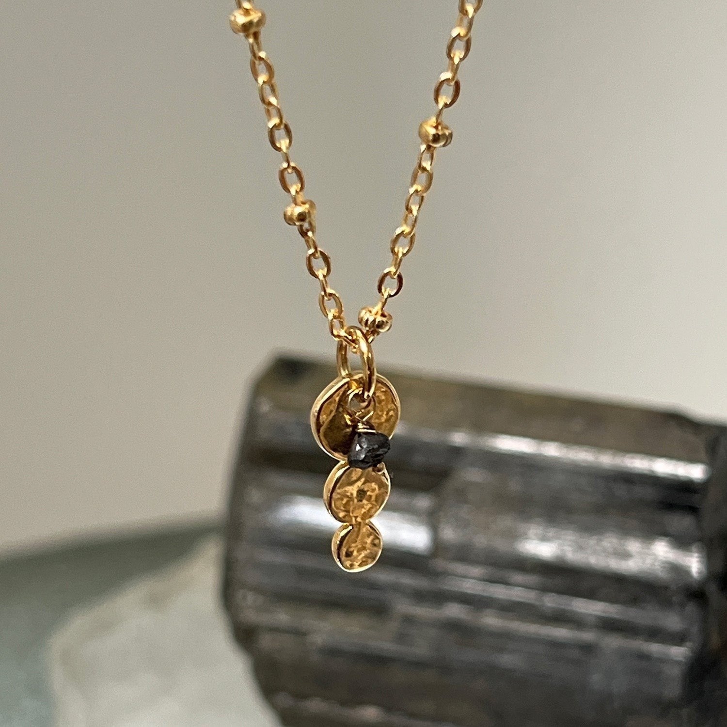 Mirabelle Jewellery gold plated Trilogy pendant with a black rough diamond on a delicate satellite chain.
