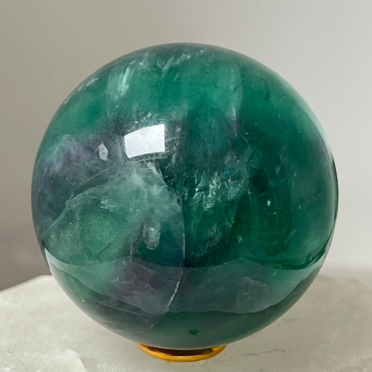Mirabelle Jewellery polished green and purple fluorite sphere, smooth, natural variations, for crystal collections and home decor.