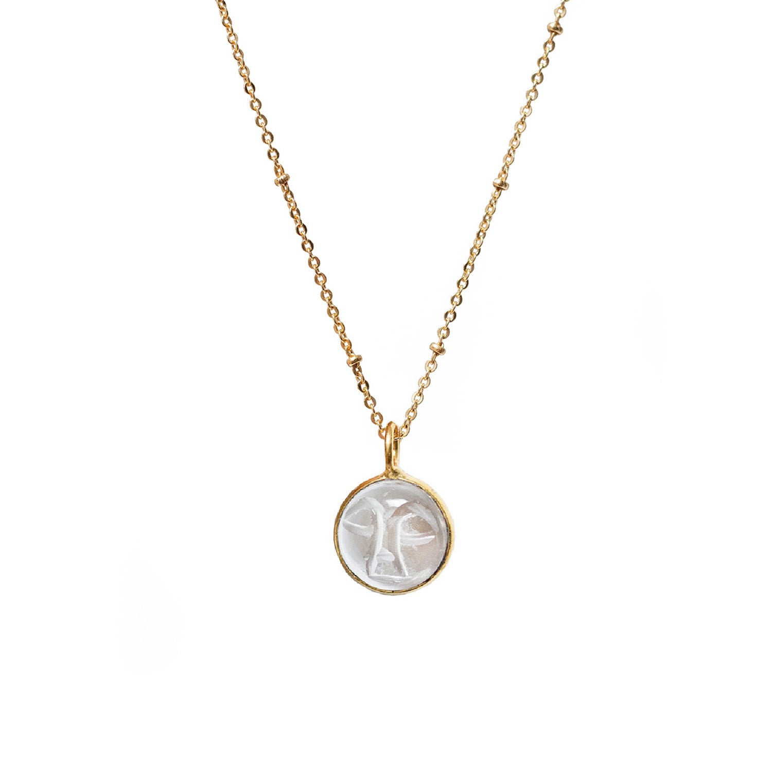 A gold-plated satellite chain necklace with a carved rock crystal moon face pendant.