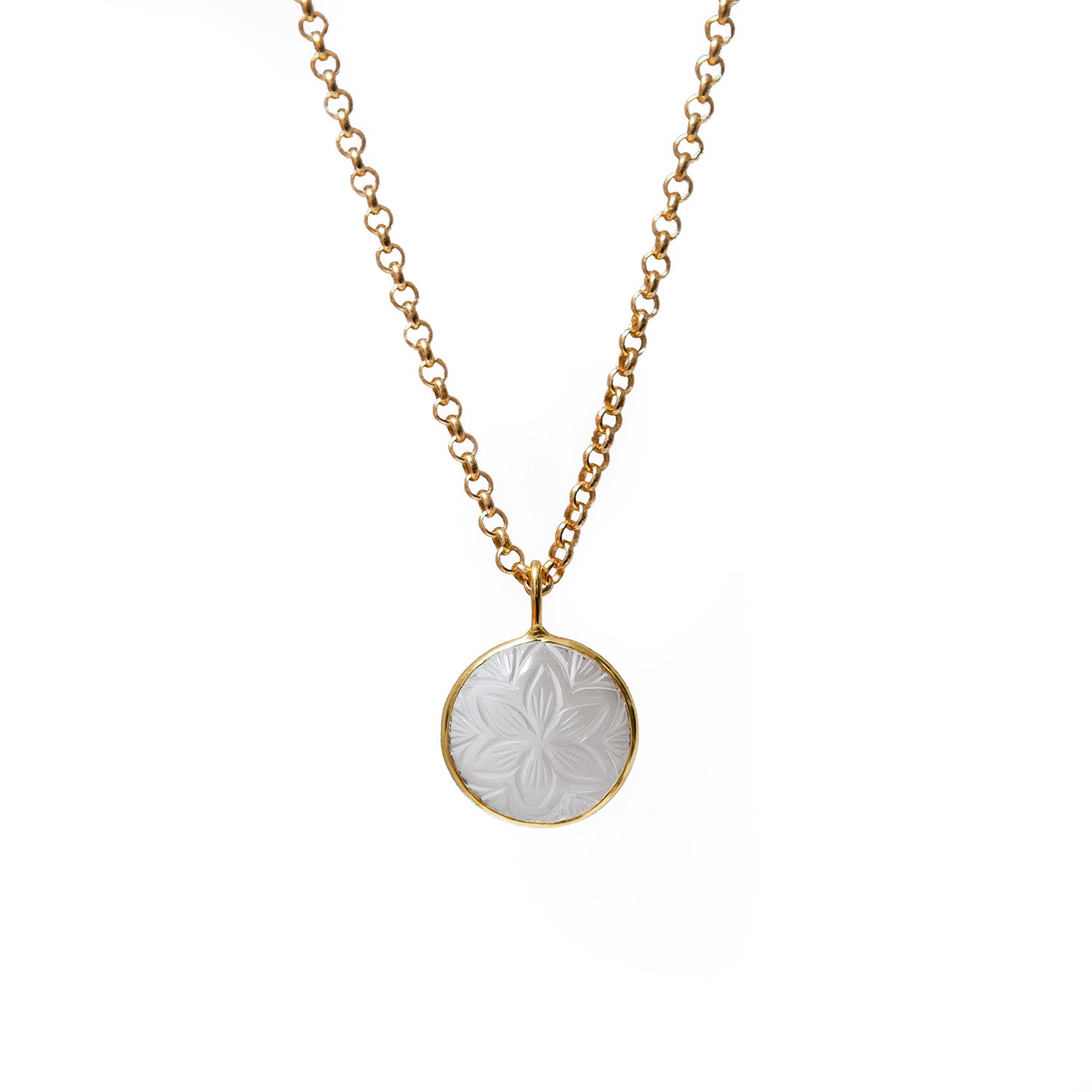 Necklace with a hand-carved flower pendant on a gold chain against a white background
