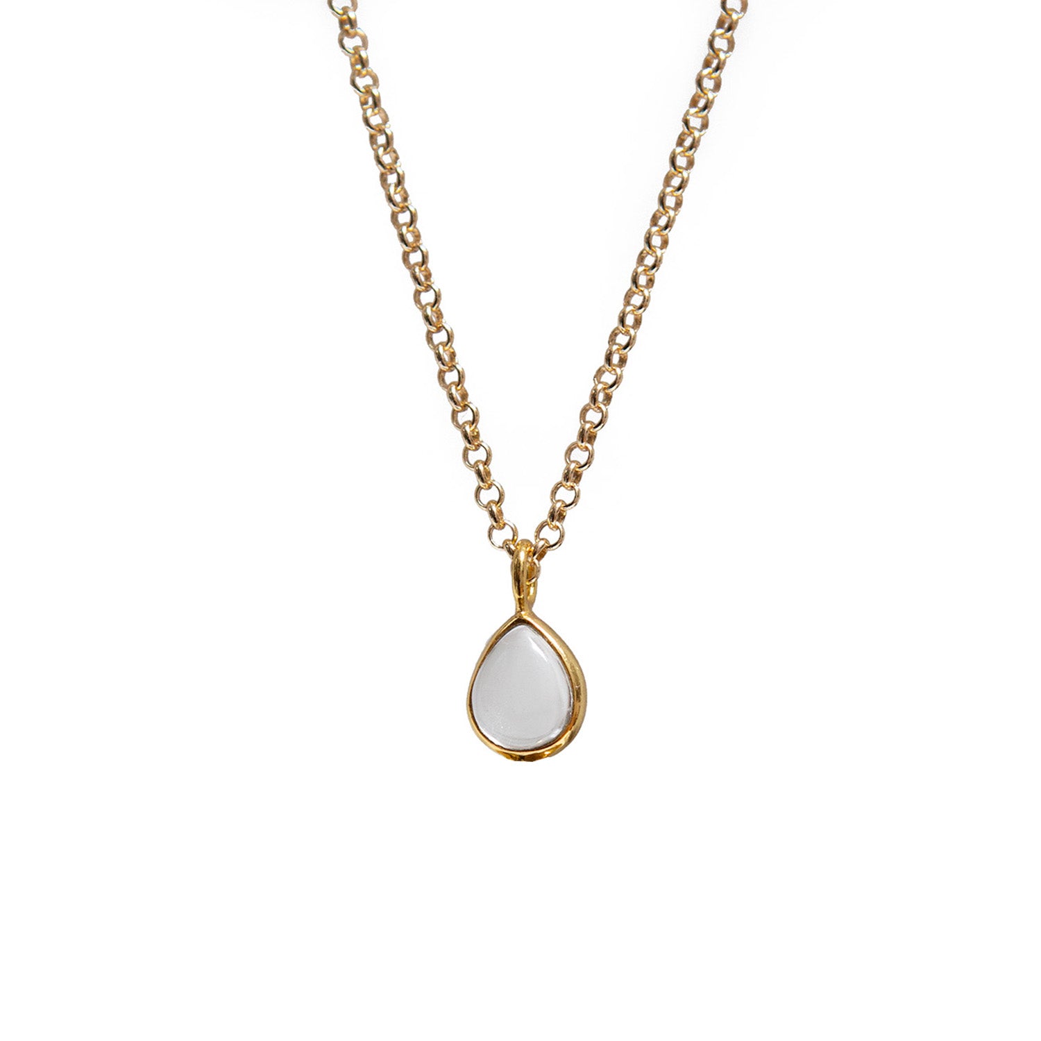 Gold necklace with a white teardrop rock crystal pendant on a white background