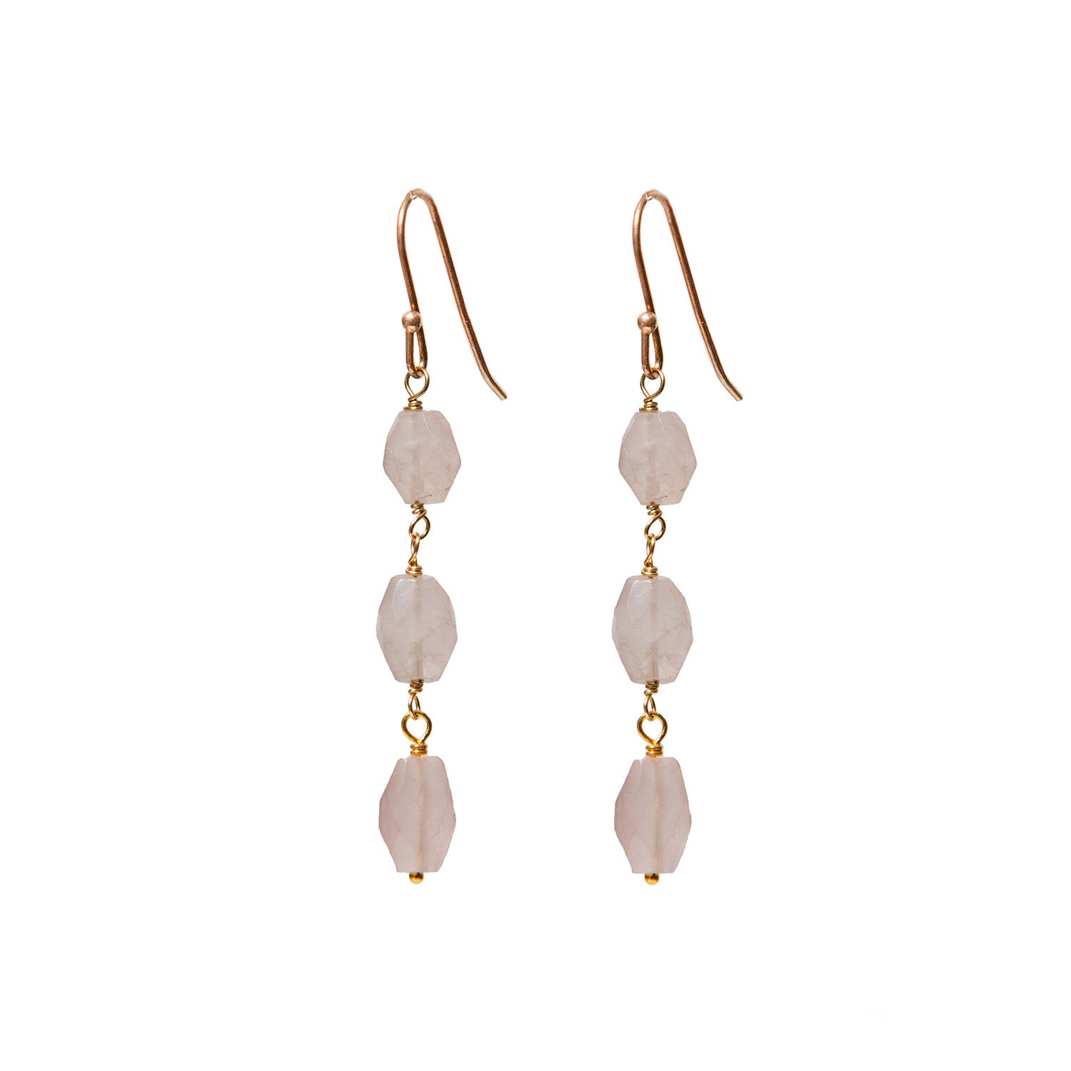 Pair of gold earrings with pink rose quartz on a white background