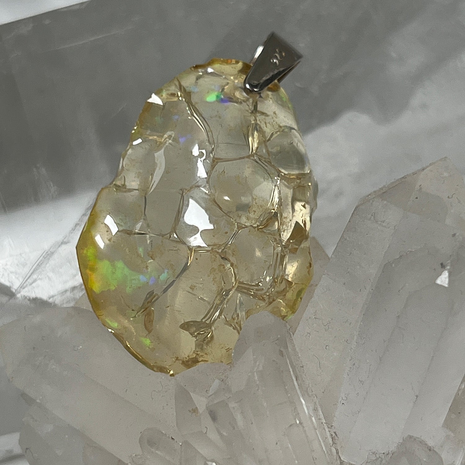 Necklace with a textured unique Ethiopian fire opal pendant on a crystal background