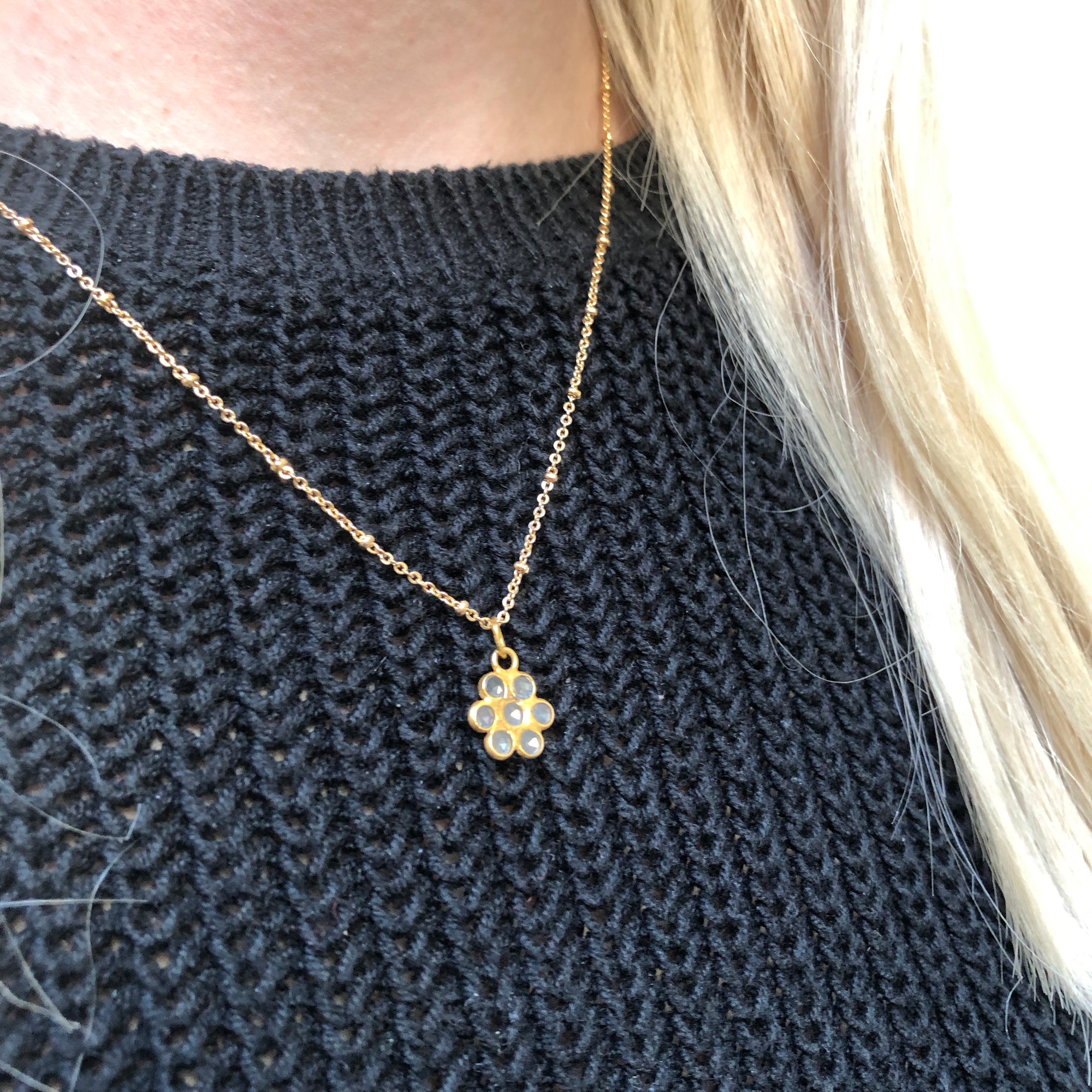 Polki Diamond Flower Pendant on a gold-plated satellite chain worn by a model with a navy jumper