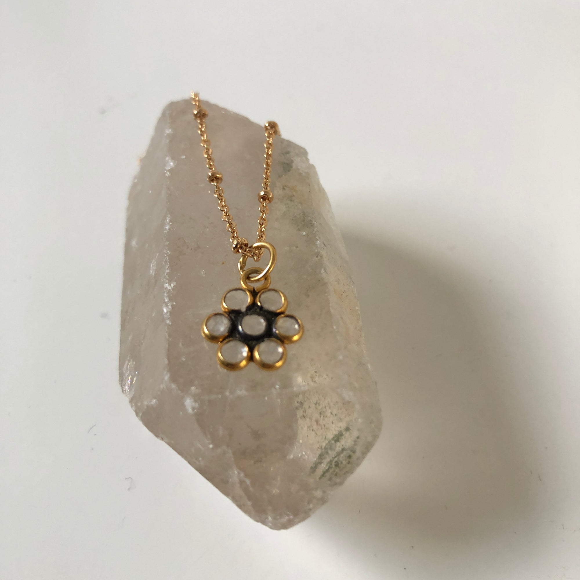 Polki Diamond Flower Pendant on a gold-plated satellite chain on a crsytal