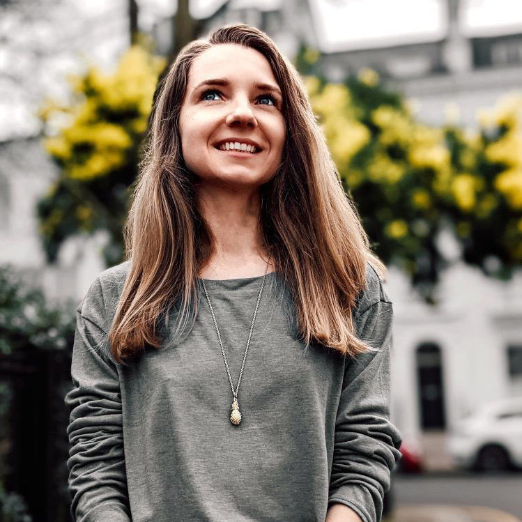 Gold Plated Pineapple Charm Pendant on a chain worn by a model, smiling