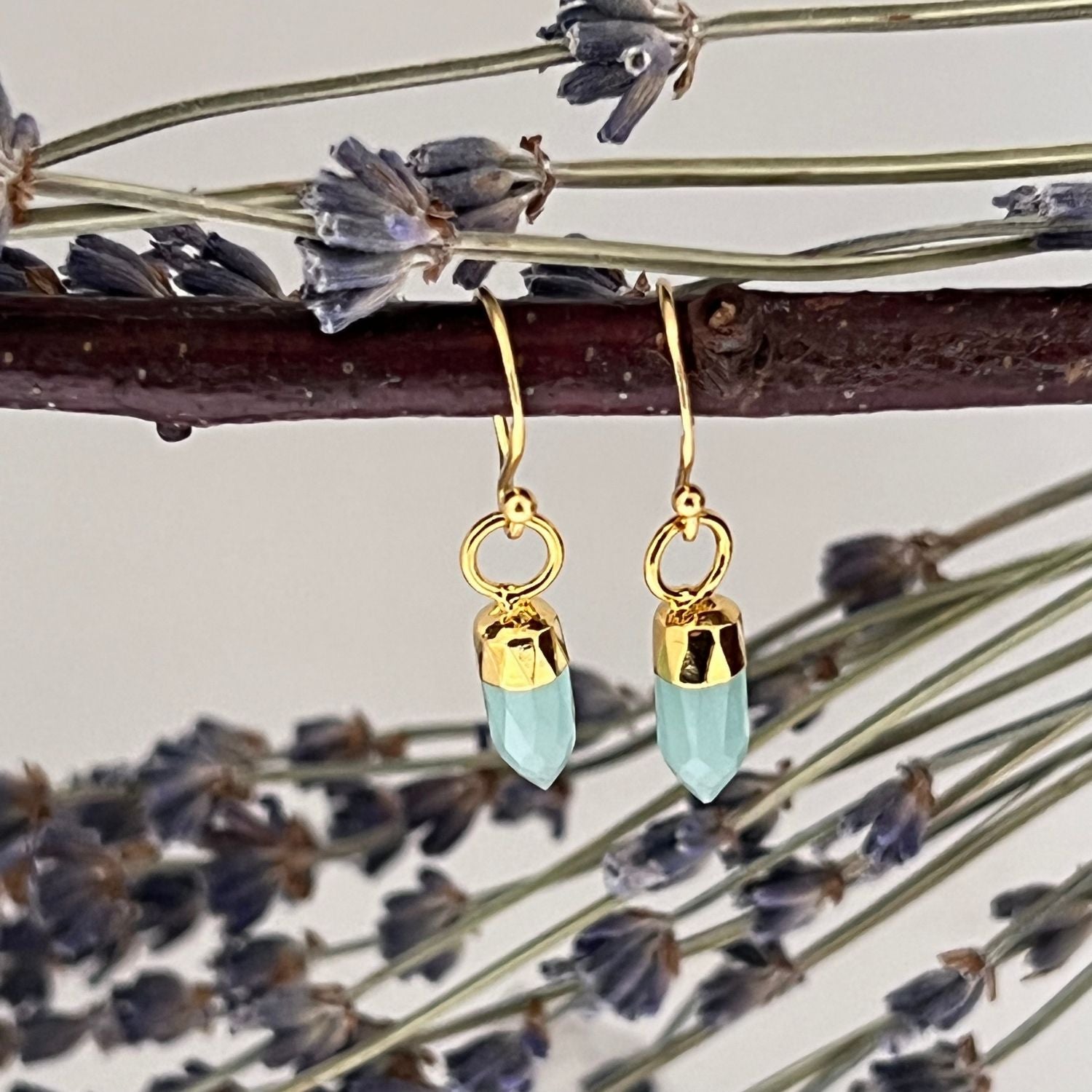 22ct gold-plated aqua chalcedony crystal earrings in a mini point design hanging from a twig