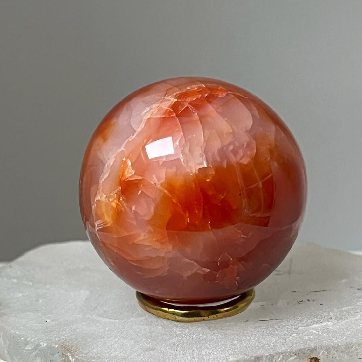 Unique Carnelian ball from Madagascar with brass ring stand