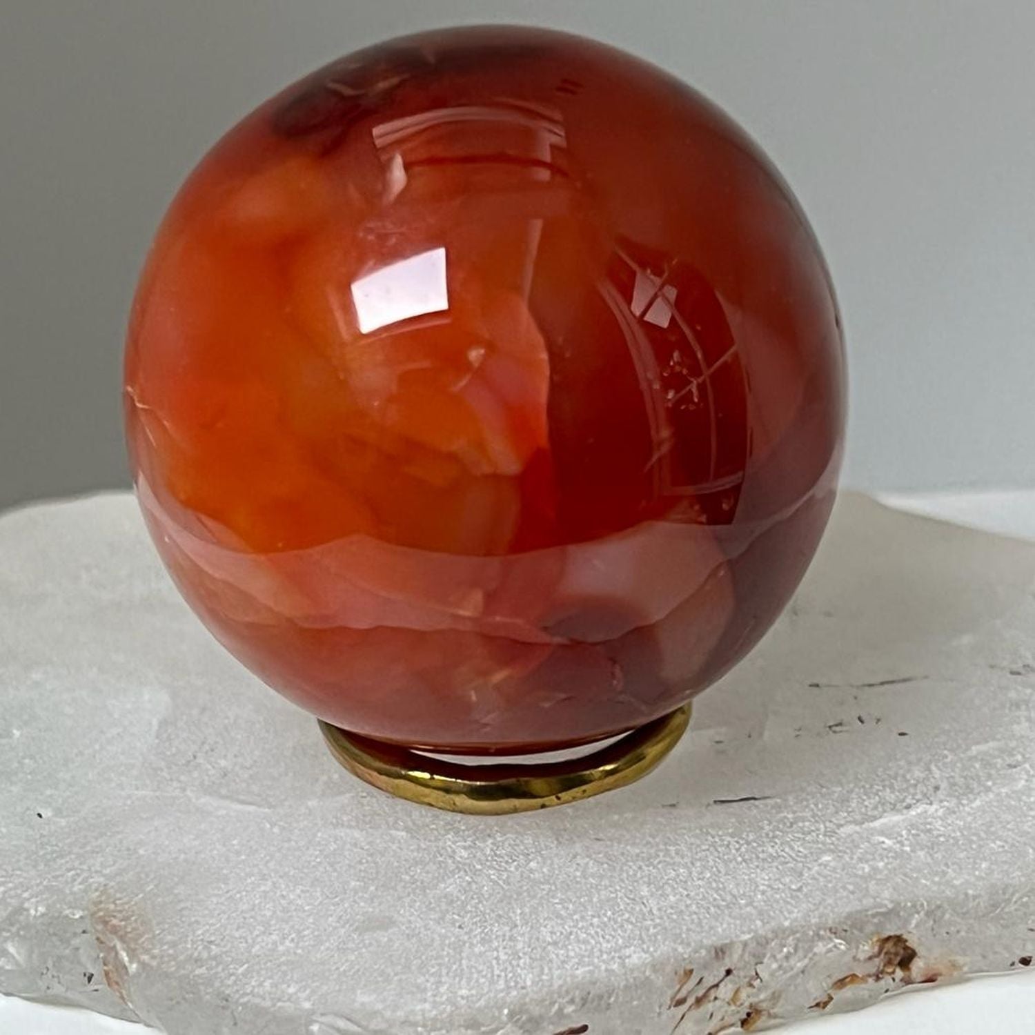 Unique Carnelian ball from Madagascar with brass ring stand