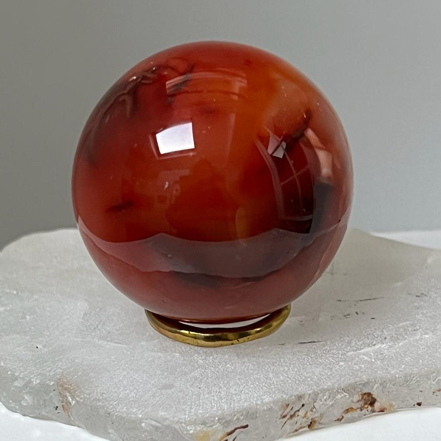Unique Carnelian ball from Madagascar with brass ring stand