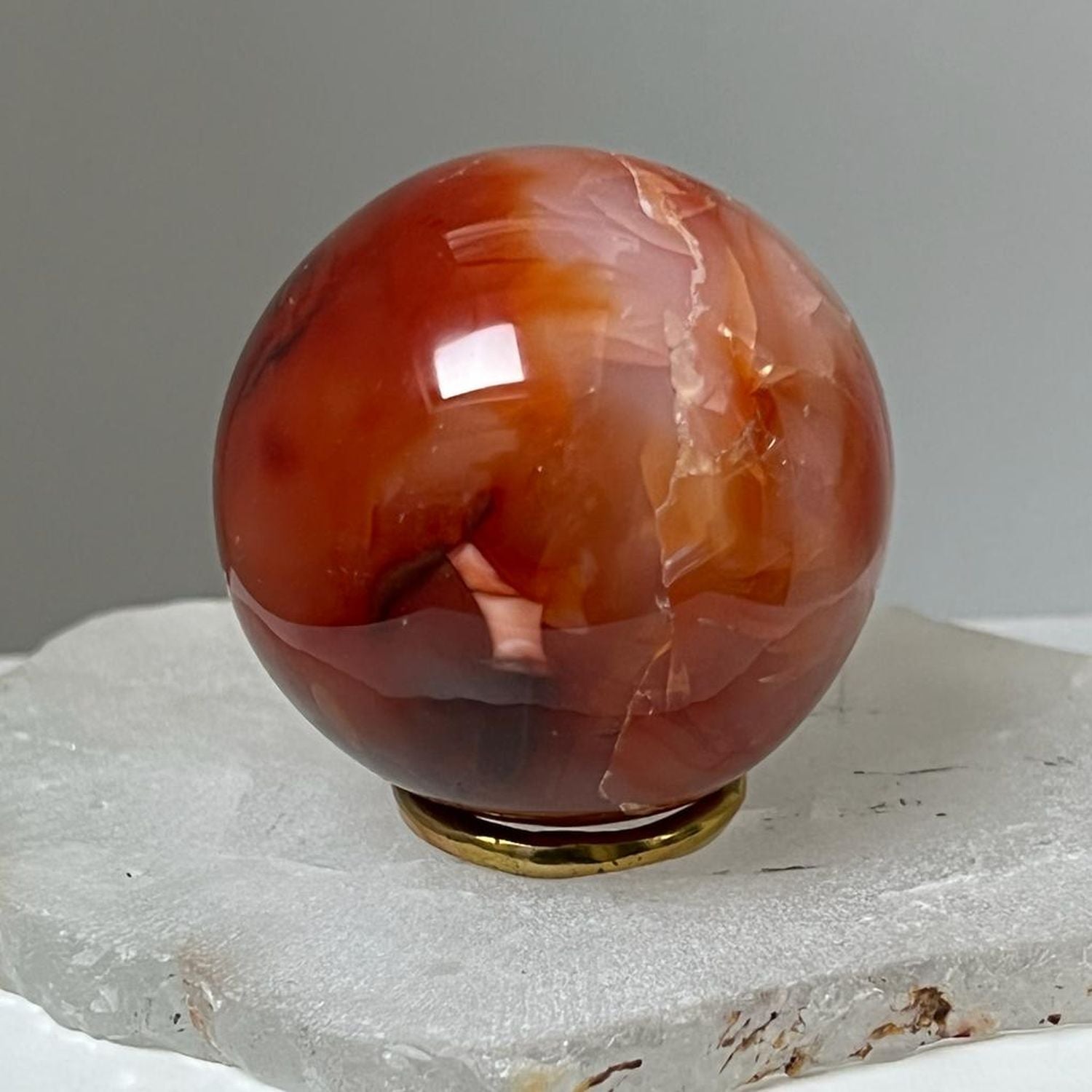 Unique Carnelian ball from Madagascar with brass ring stand