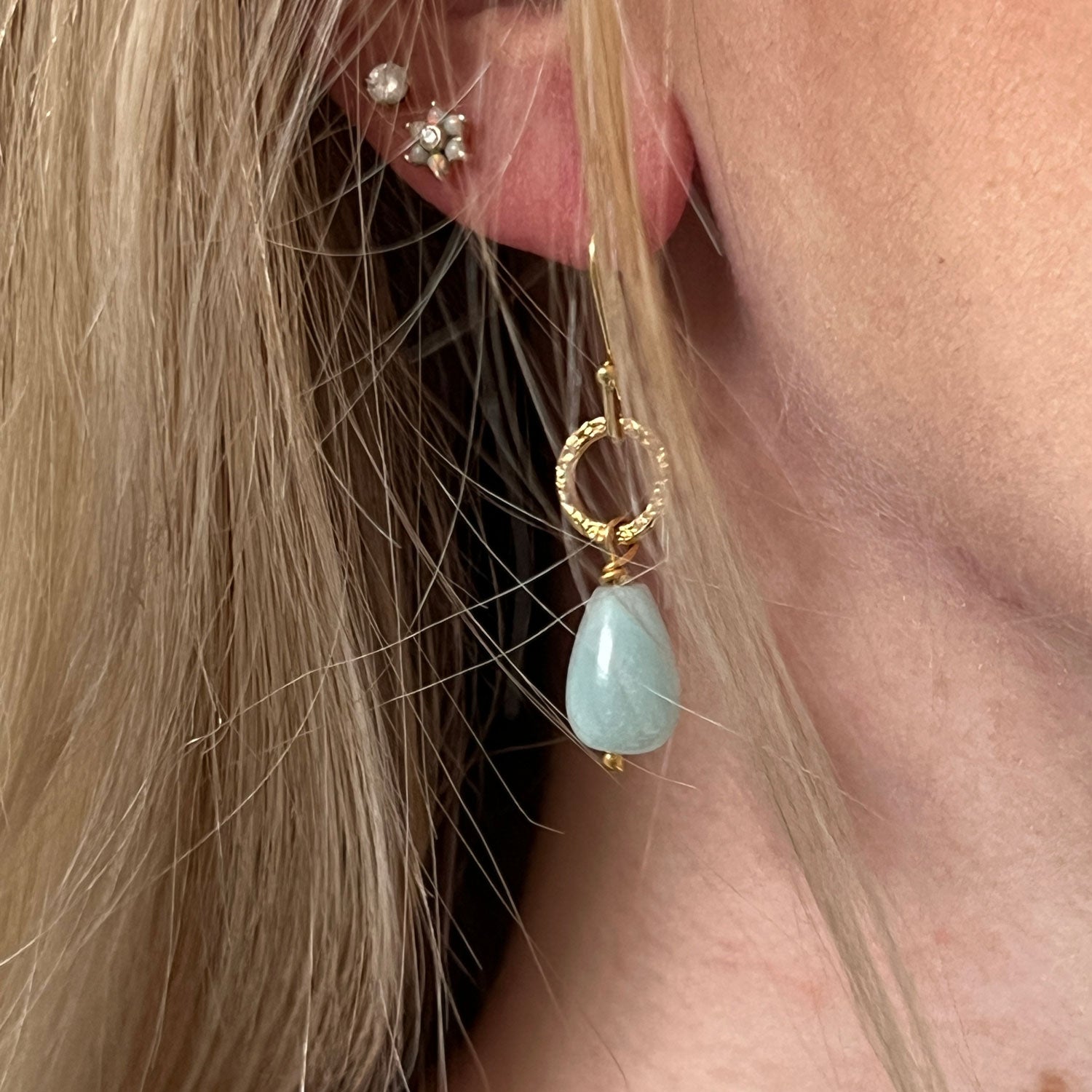 22ct gold plated earrings with calming amazonite stones worn on a model.