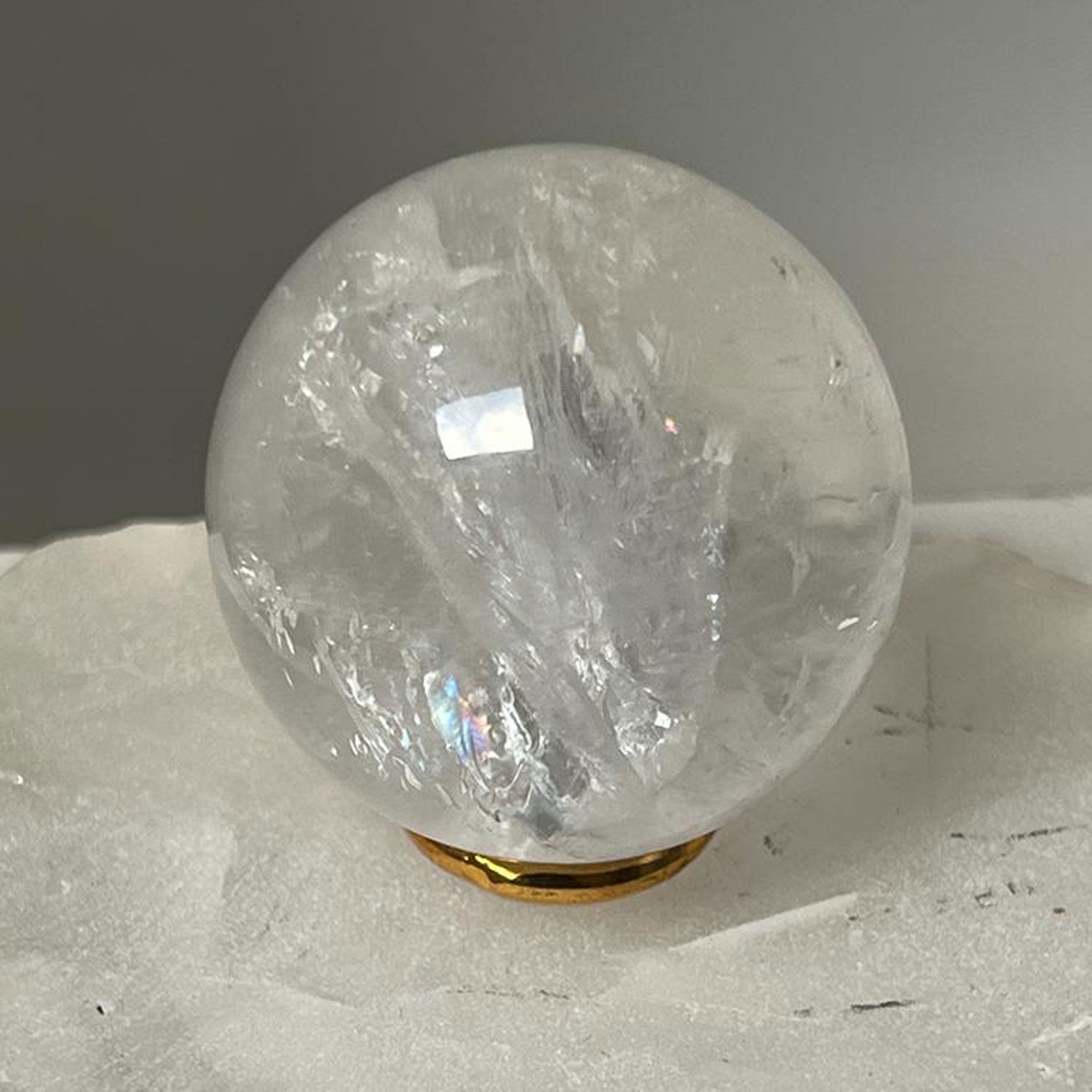 Unique Rock crystal ball with brass ring stand from Madagascar