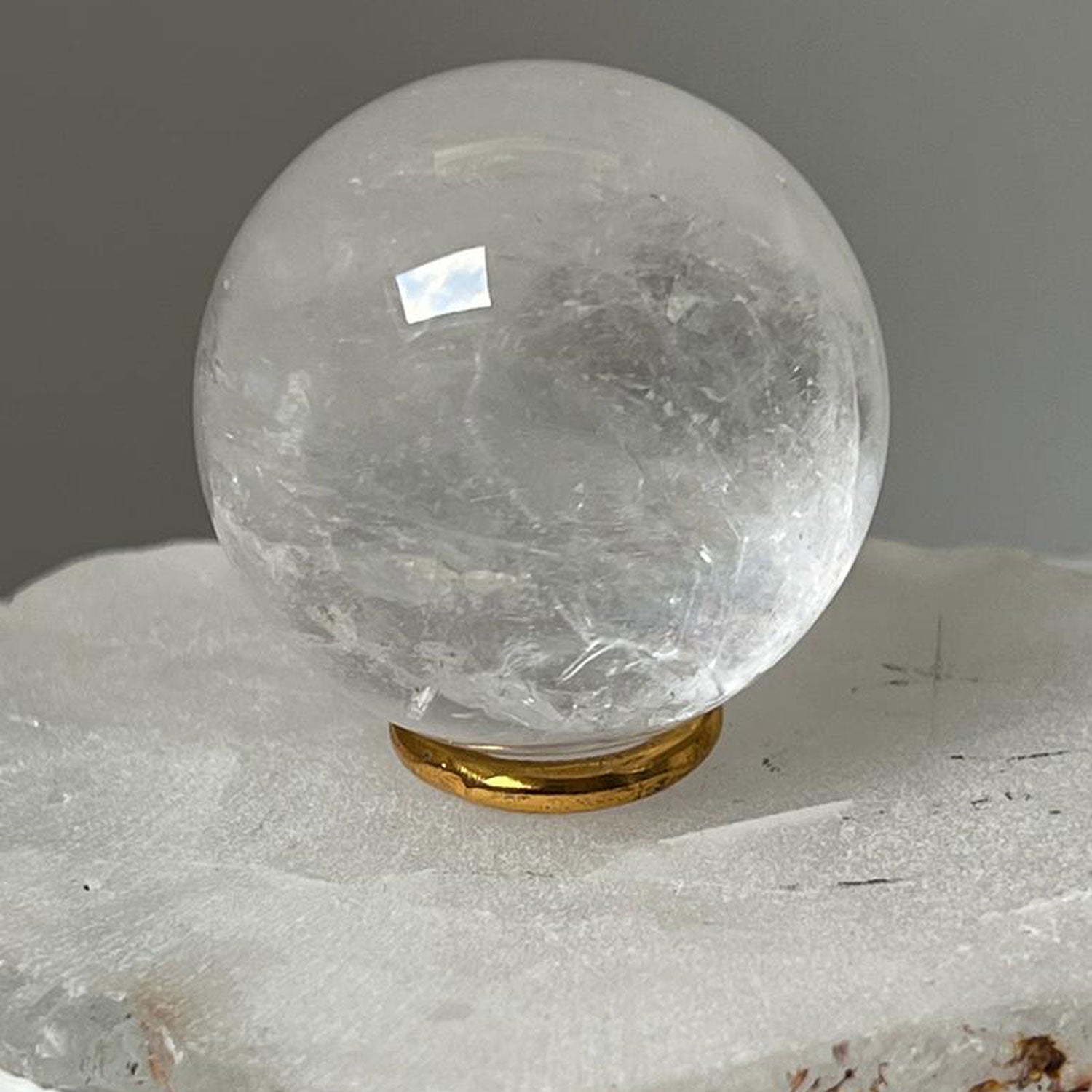 Unique Rock crystal ball with brass ring stand from Madagascar