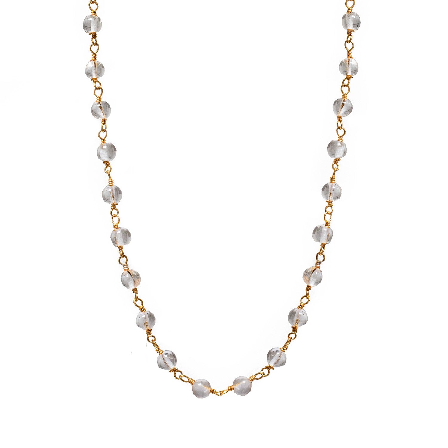 Delicate gold chain necklace featuring clear faceted rosary beads evenly spaced along the length