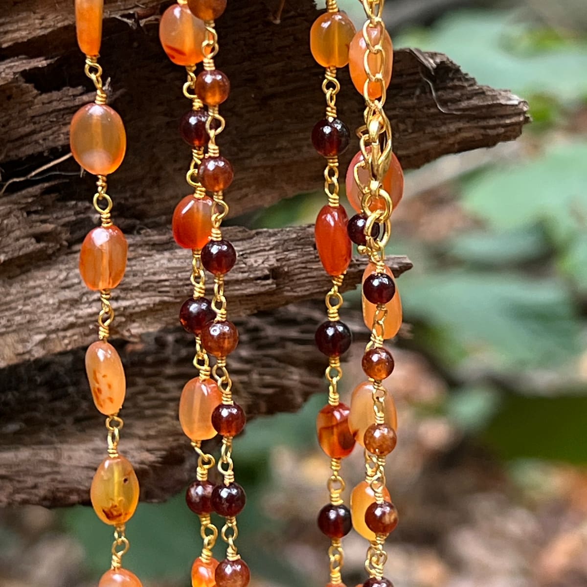 Necklace with orange and brown beads on a wooden surface