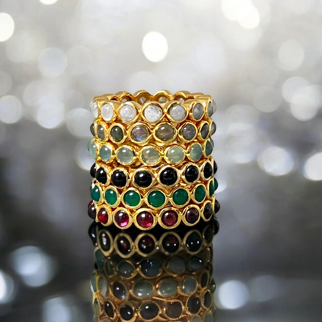 A stack of differnet coloured eternity rings