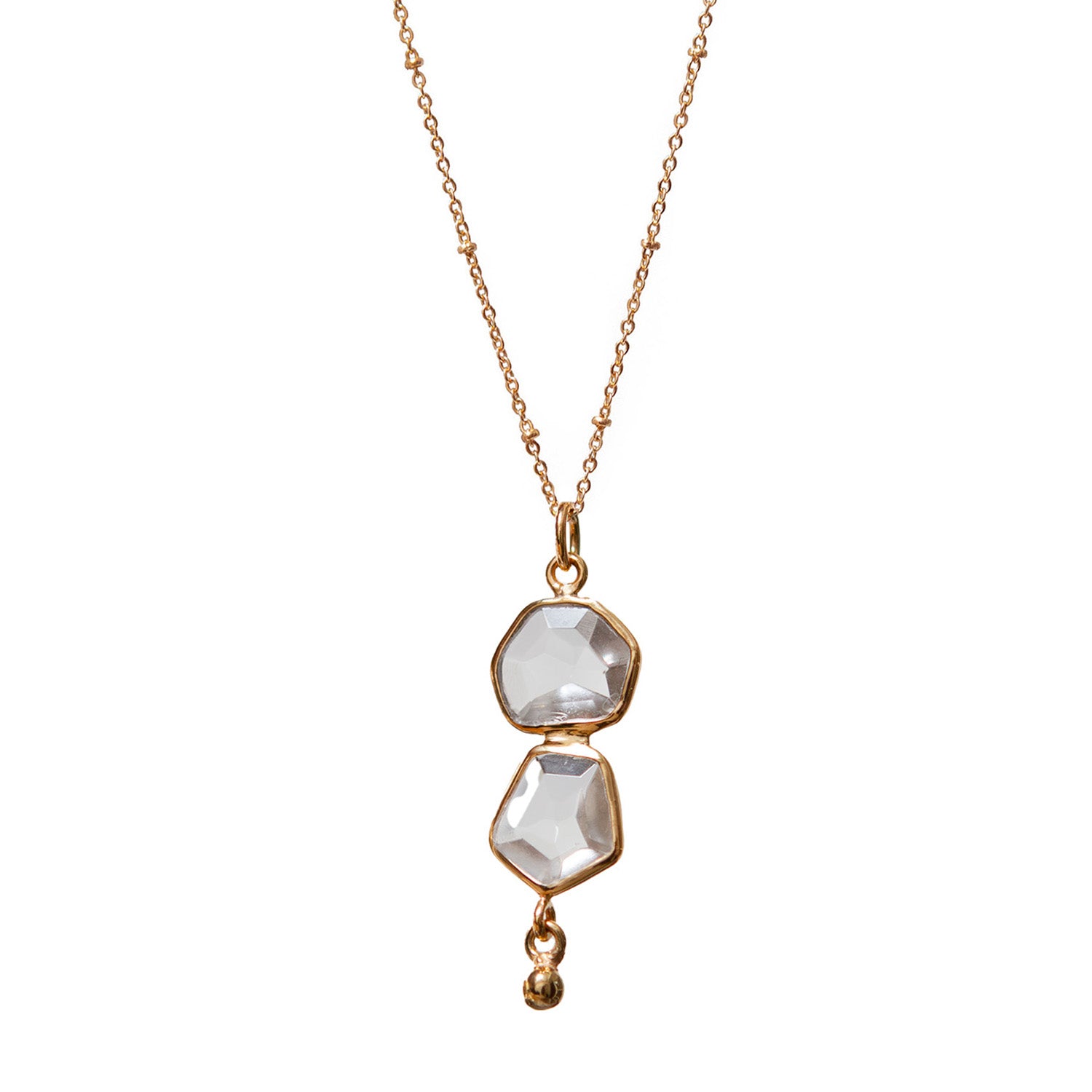 Gold necklace with two clear gemstones on a white background