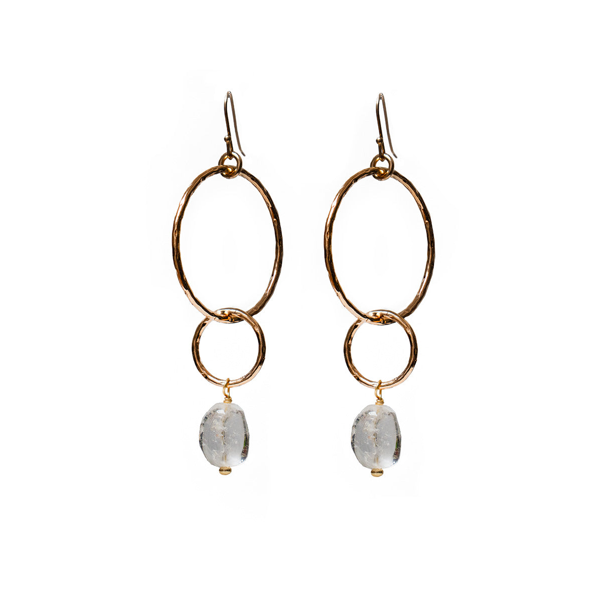 Gold hoop earrings with a freeform rock crystal on a white background
