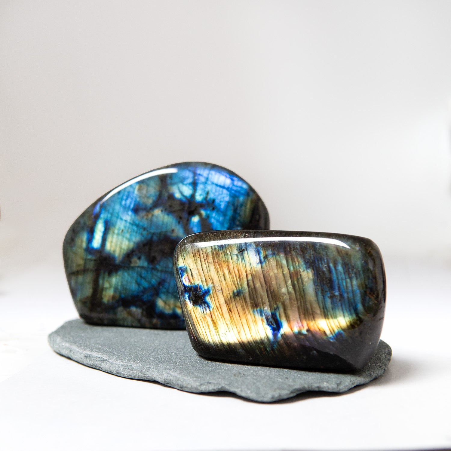 Two labradorite stones on a white background