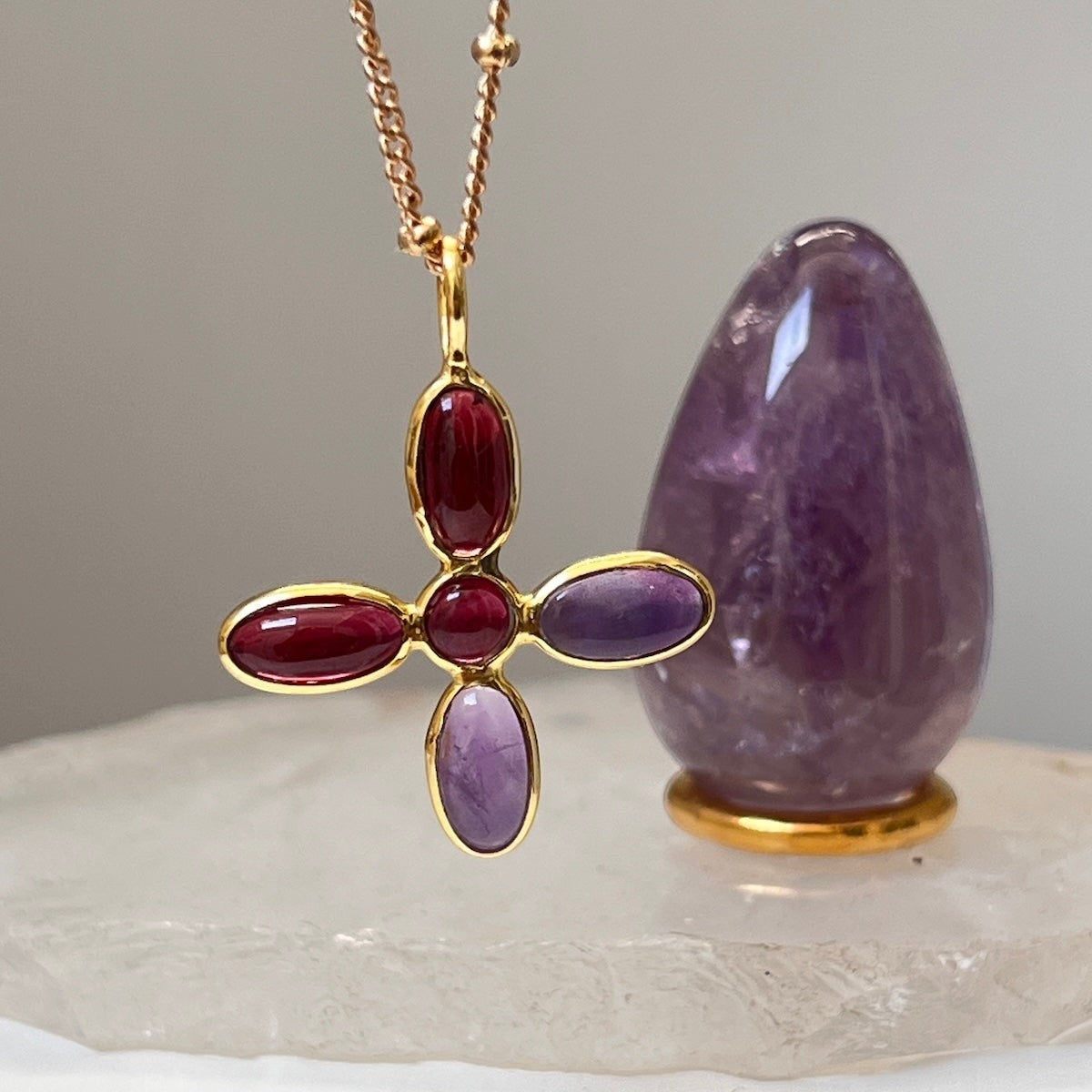 Mirabelle Jewellery large cross pendant with amethyst and garnet stones on a gold-plated brass rosary chain.