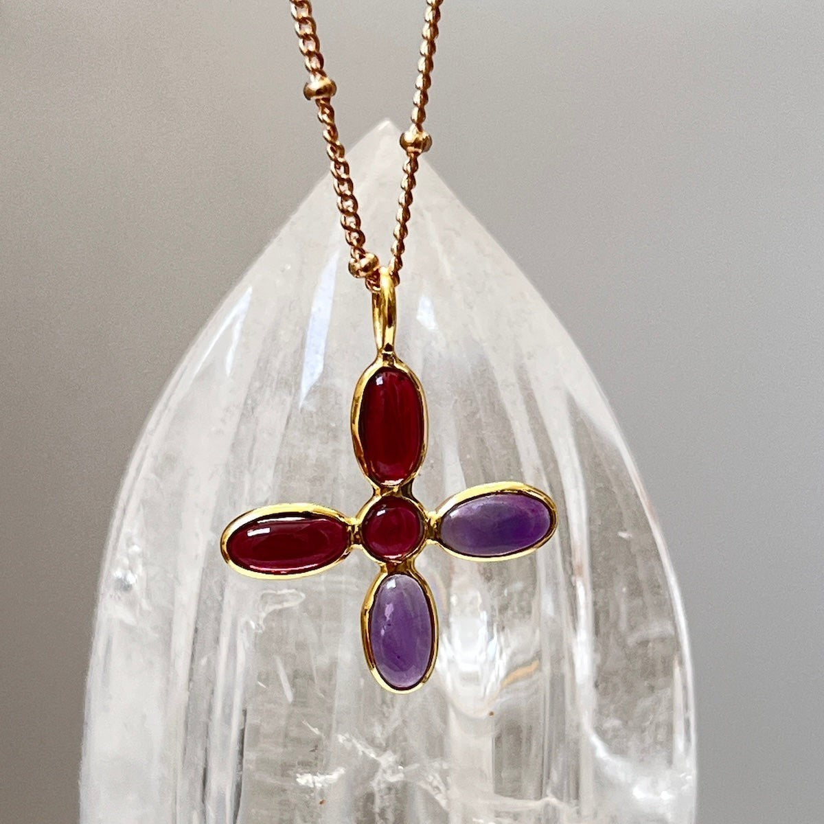 Mirabelle Jewellery large cross pendant with amethyst and garnet stones on a gold-plated brass rosary chain.
