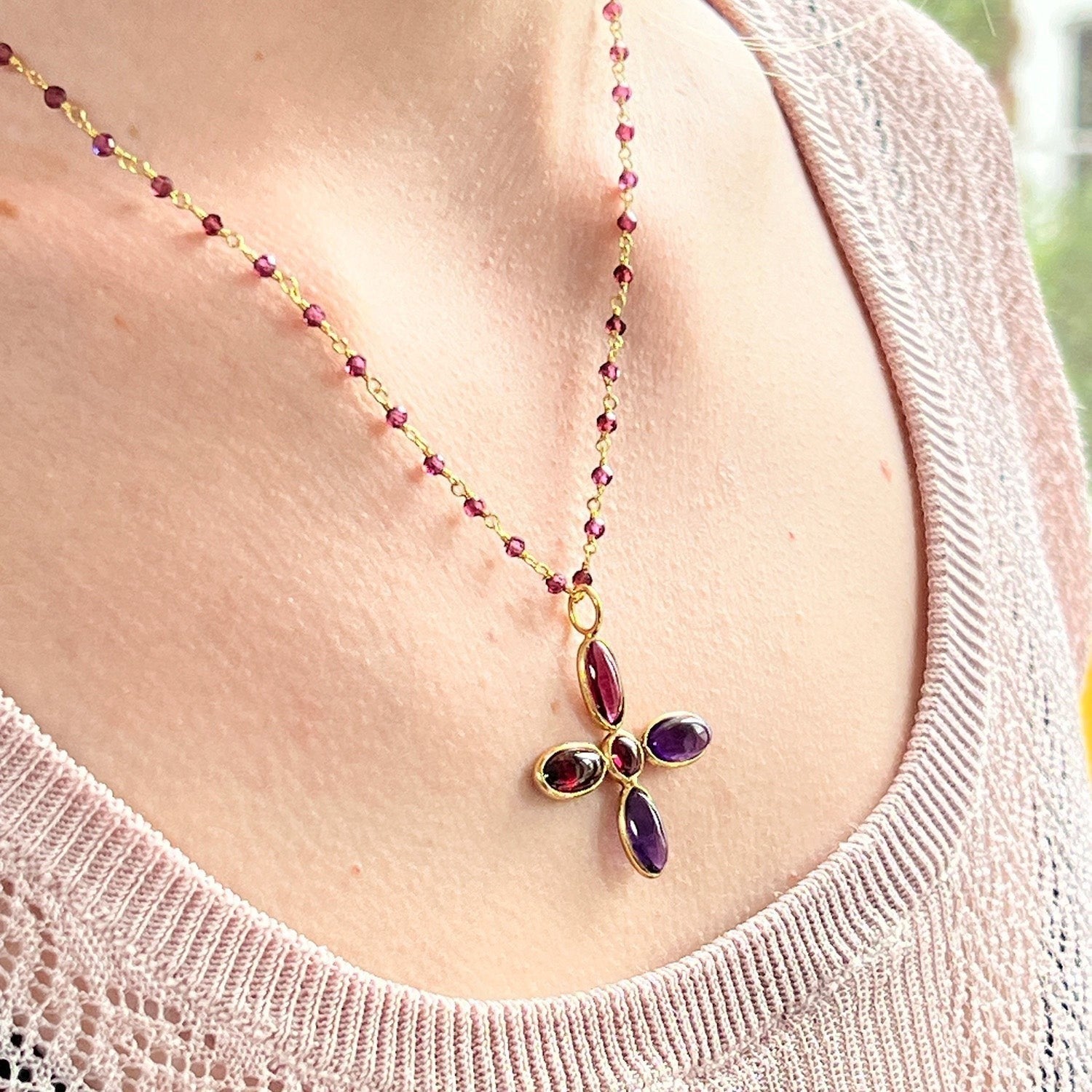 Mirabelle Jewellery large amethyst and garnet cross pendant on a gold-plated brass rosary chain with small purple garnet beads.