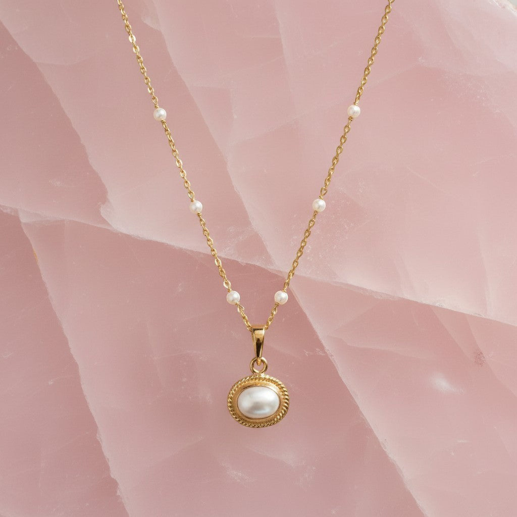 Mirabelle Jewellery Athena freshwater pearl pendant on a gold plated brass rosary chain with small pearl accents.