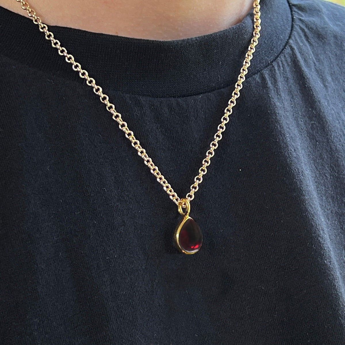 Mirabelle Jewellery dark garnet teardrop pendant on a delicate 22ct gold plated baby belcher chain worn at the collarbone