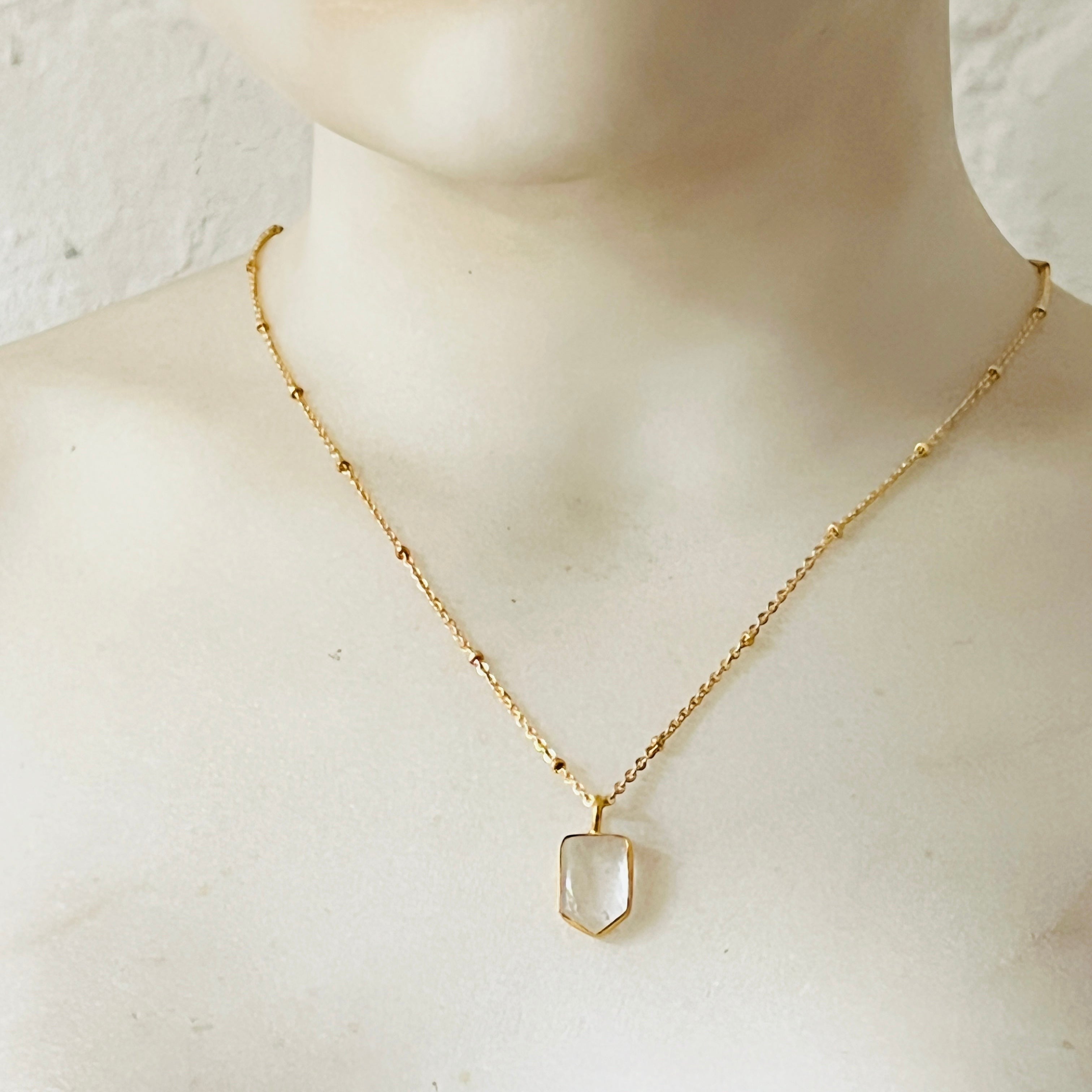 Mirabelle Jewellery Mini Temple necklace featuring a clear rock crystal pendant on a gold-plated satellite chain.