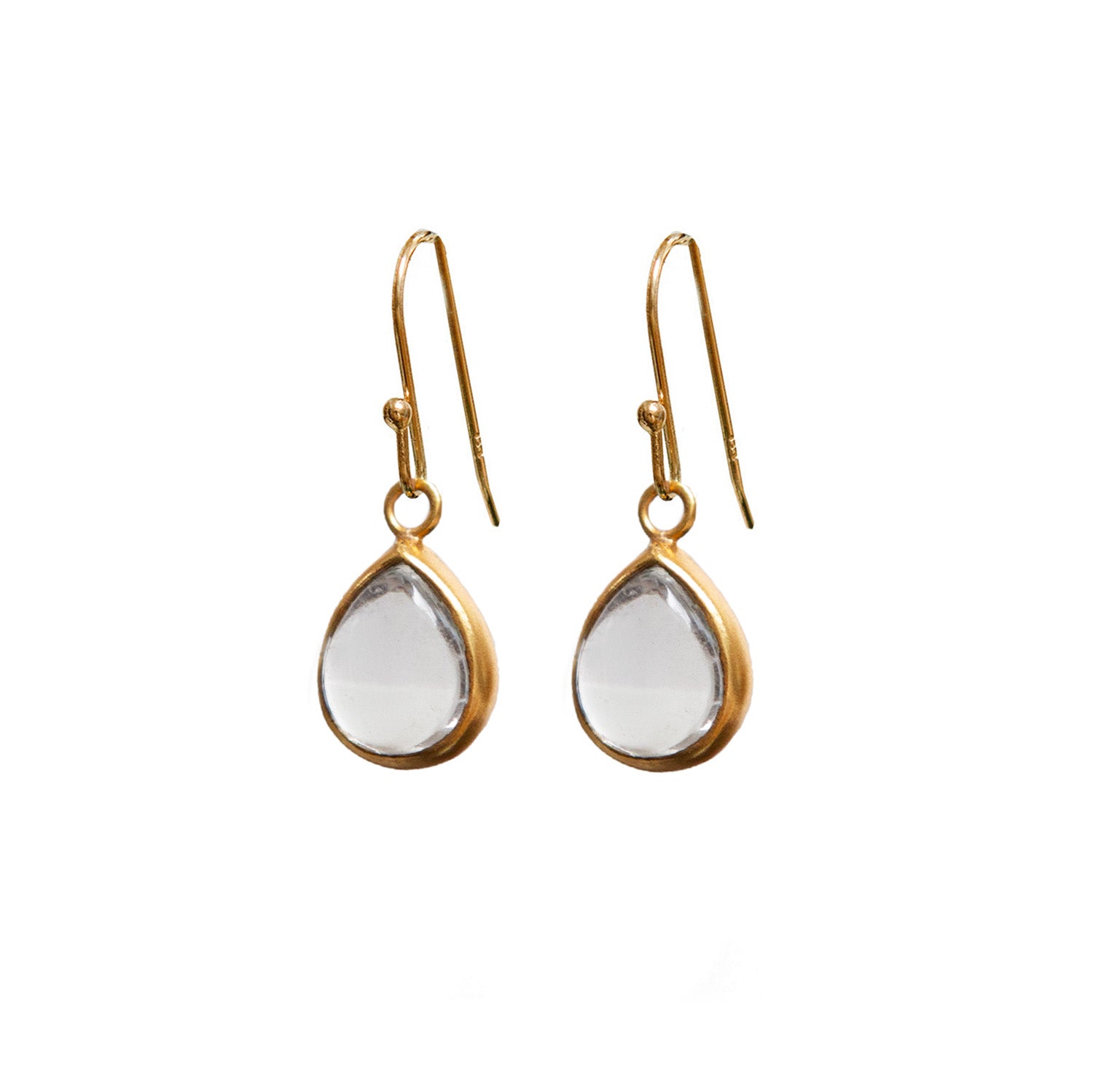 Gold earrings with teardrop-shaped rock crystals on a white background