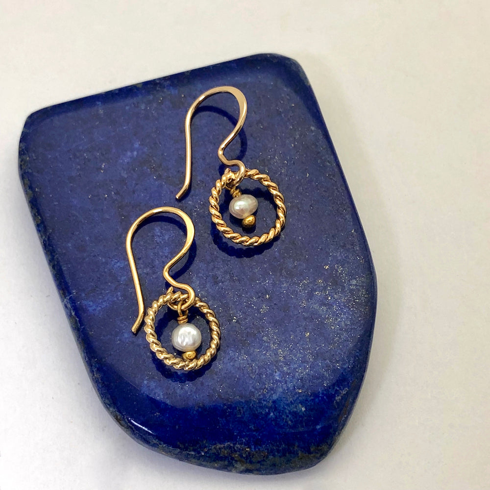 Alexis Freshwater Pearl Earrings displayed on a blue crystal